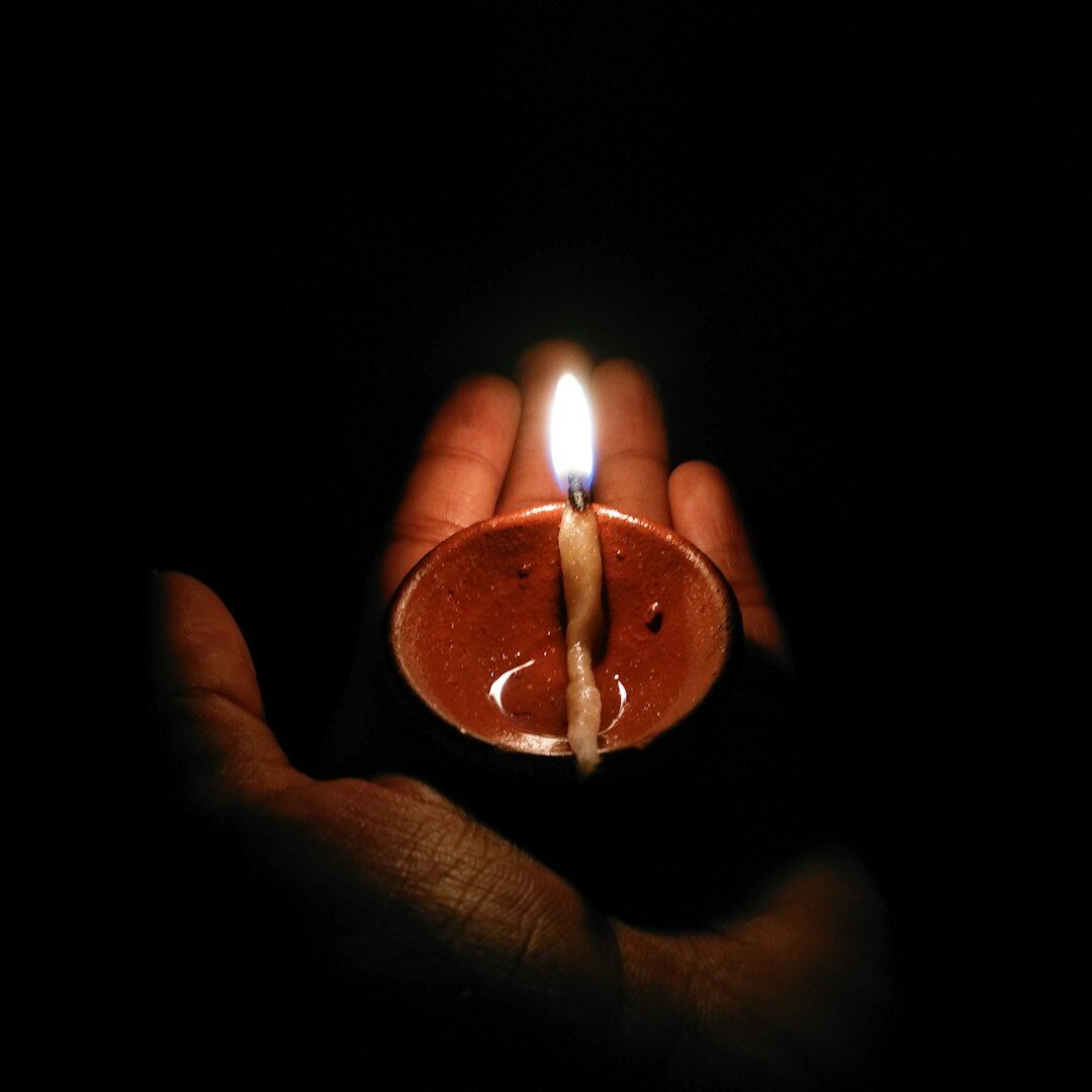 Hand holding a glowing light bulb representing creative ideas